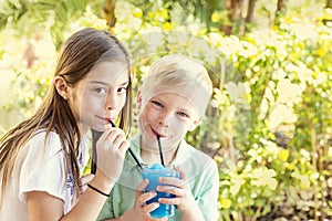 Cute kids sharing a delicious flavored ice drink together photo