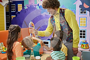 Cute kids watching science experiment with water.