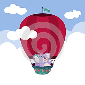 Cute Koala is flying in a balloon high in the sky. Summer happiness.
