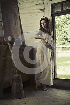 Cute lady with bare feet in the rural house