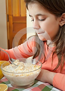 Cute latin girl eating breakfast at home