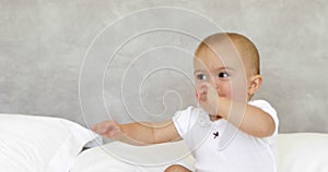 Cute laughing baby on bed