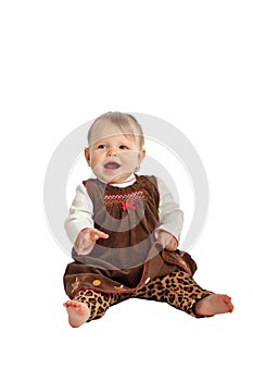 Cute laughing baby in brown velvet dress