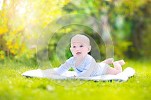 Cute laughing baby in the sunny garden