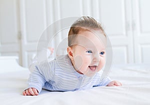 Cute laughing little baby enjoying her tummy time