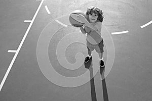 Cute litle child boy training basketball. Kids basketball school.