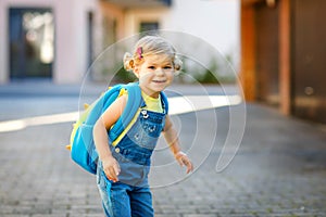 Cute little adorable toddler girl on her first day going to playschool. Healthy beautiful baby walking to nursery school