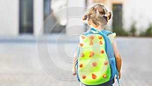 Cute little adorable toddler girl on her first day going to playschool. Healthy beautiful baby walking to nursery school