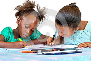 Cute little african girls drawing together at desk