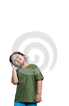 Cute little asia girl in casual clothes talking on mobile phone and smiling