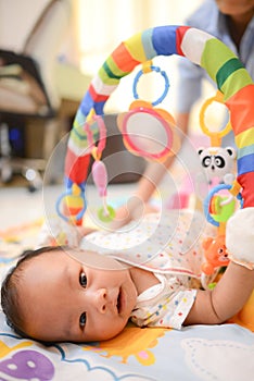 Cute little Asian baby playing Playgym