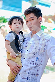Cute little  Asian boy and father Happy smilling  in the park outdoors , Happy kids