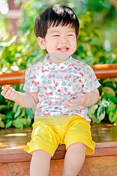 Cute little  Asian boy Happy smilling  in the park outdoors , Happy kids