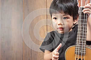 Cute Little Asian Boy with ukulele.