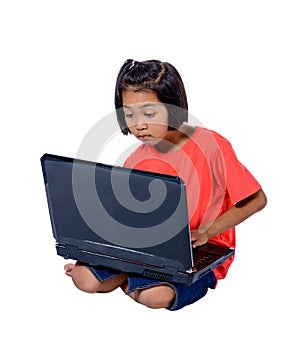 Cute little Asian girl child sitting on the floor studying or using laptop isolated on white background