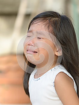 Cute little asian girl crying