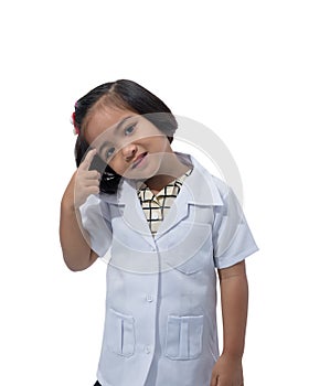 Cute Little asian girl doctor smiling while wearing Doctor`s uniform