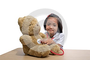 Cute Little asian girl doctor smiling while wearing Doctor`s uniform