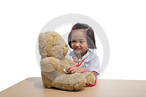 Cute Little asian girl doctor smiling while wearing Doctor`s uniform playing