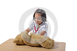 Cute Little asian girl doctor smiling while wearing Doctor`s uniform playing