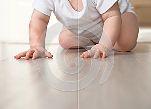 Cute little baby before and after allergy treatment crawling on floor indoors
