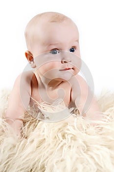 A cute little baby. The baby could be a boy or girl and has blue eyes.