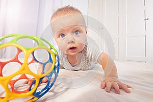 Cute little baby boy toddler crawl after color toy