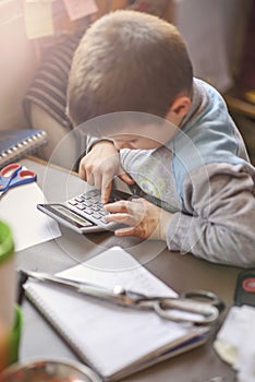 Cute little baby boy using a calculator