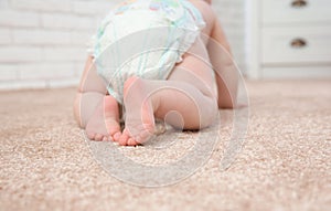 Cute little baby crawling on carpet indoors