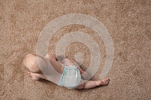 Cute little baby crawling on carpet indoors, with space for text