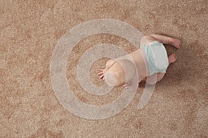 Cute little baby crawling on carpet indoors, with space for text