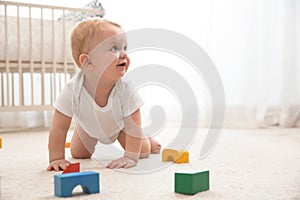 Cute little baby crawling on carpet indoors