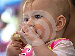 Cute little baby girl eating