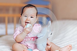 Cute little baby girl, playing with colorful easter eggs