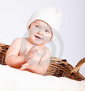 Cute little baby infant in basket with teddy