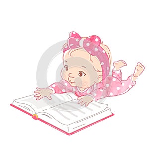 Cute little baby lay on stomach, reading book