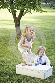Cute little baby on the meadow field. Toddler child walking outdoor, family vacations, summer season nature. Children on