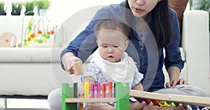 Cute little baby with mom. Mother and son playing education toy. boy and woman playing together.