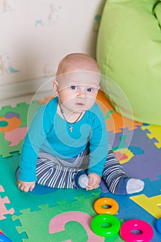 Cute little baby playing with colorful toys