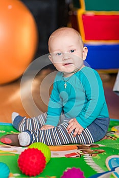 Cute little baby playing with colorful toys