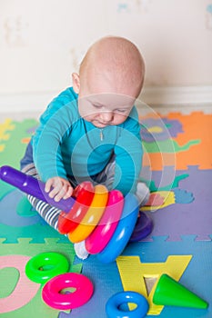 Cute little baby playing with colorful toys