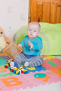 Cute little baby playing with colorful toys