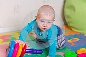 Cute little baby playing with colorful toys