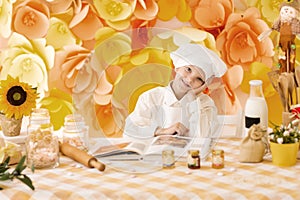 Cute little baby is preparing tasty meals in the kitchen