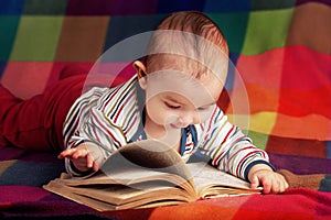 Cute little baby reading book