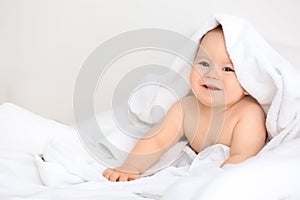 Cute little baby with soft towel on white background