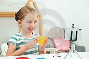 Cute little blogger with handcrafting recording video