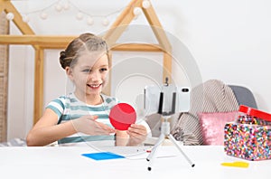 Cute little blogger with handcrafting recording video