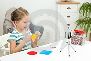 Cute little blogger with handcrafting recording video