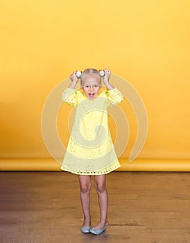 Cute little blonde with bright emotions - attention, mystery, silence, interest.